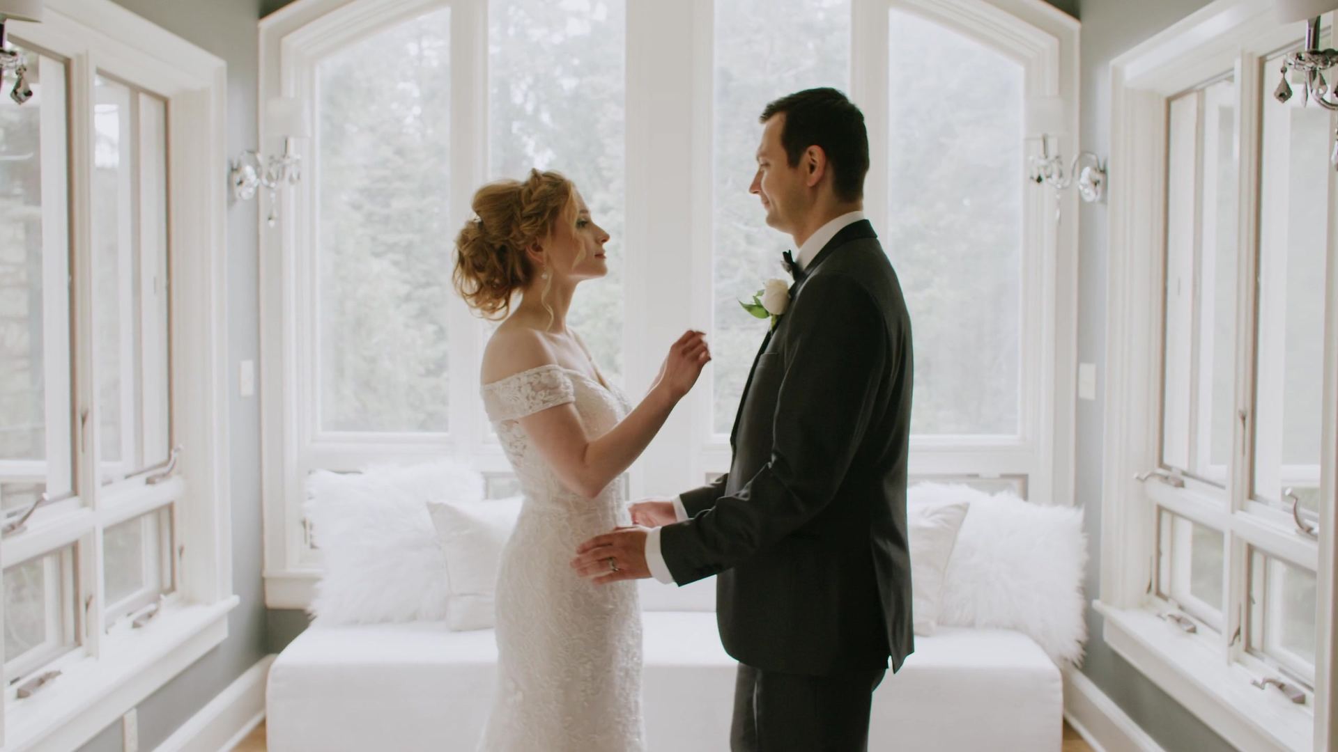 Peter and Julya's first look in the sunroom, tall arched windows on every side.