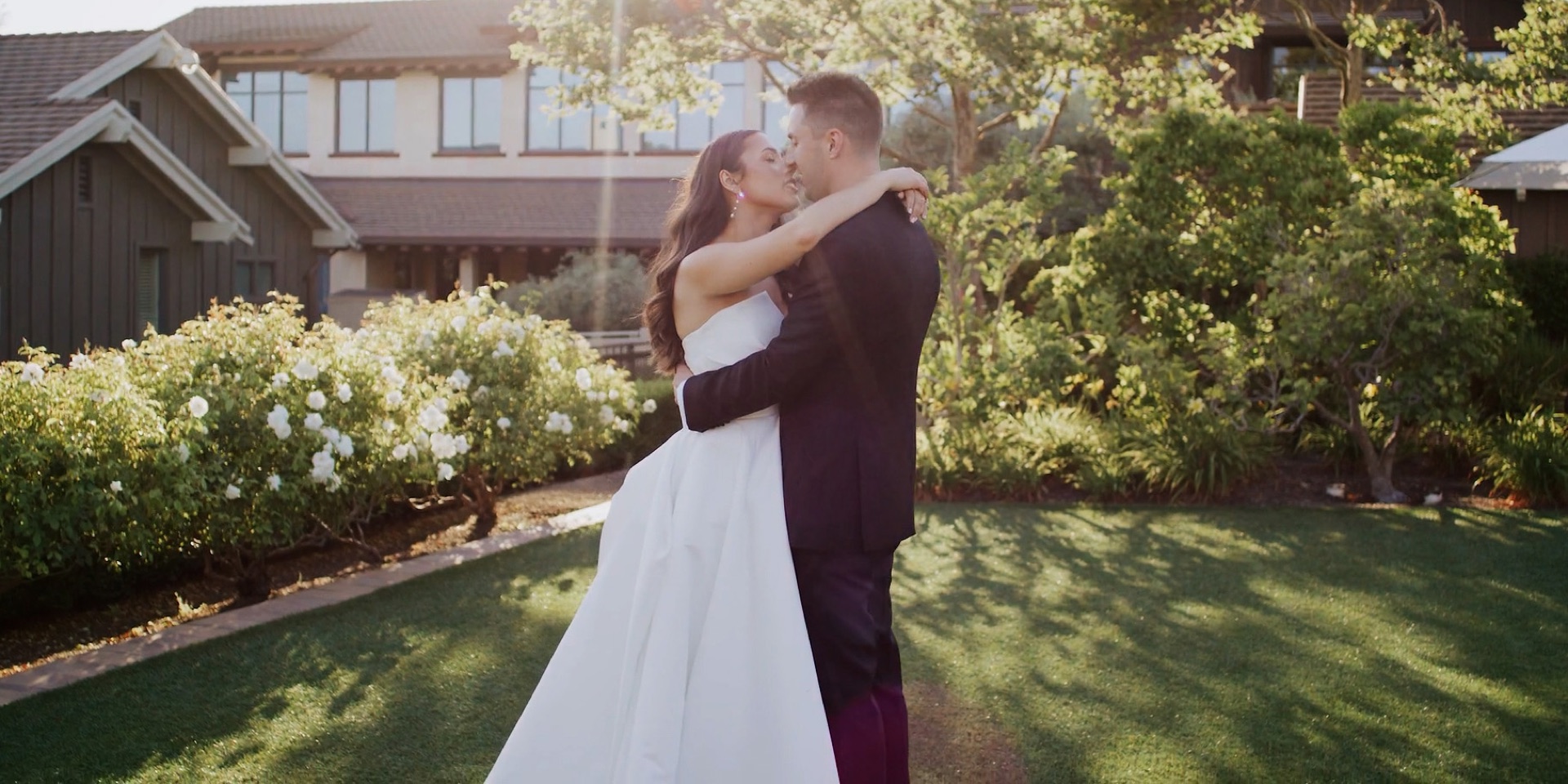 Bride and groom embracing at golden hour on the Rosewood Sand Hill lawn