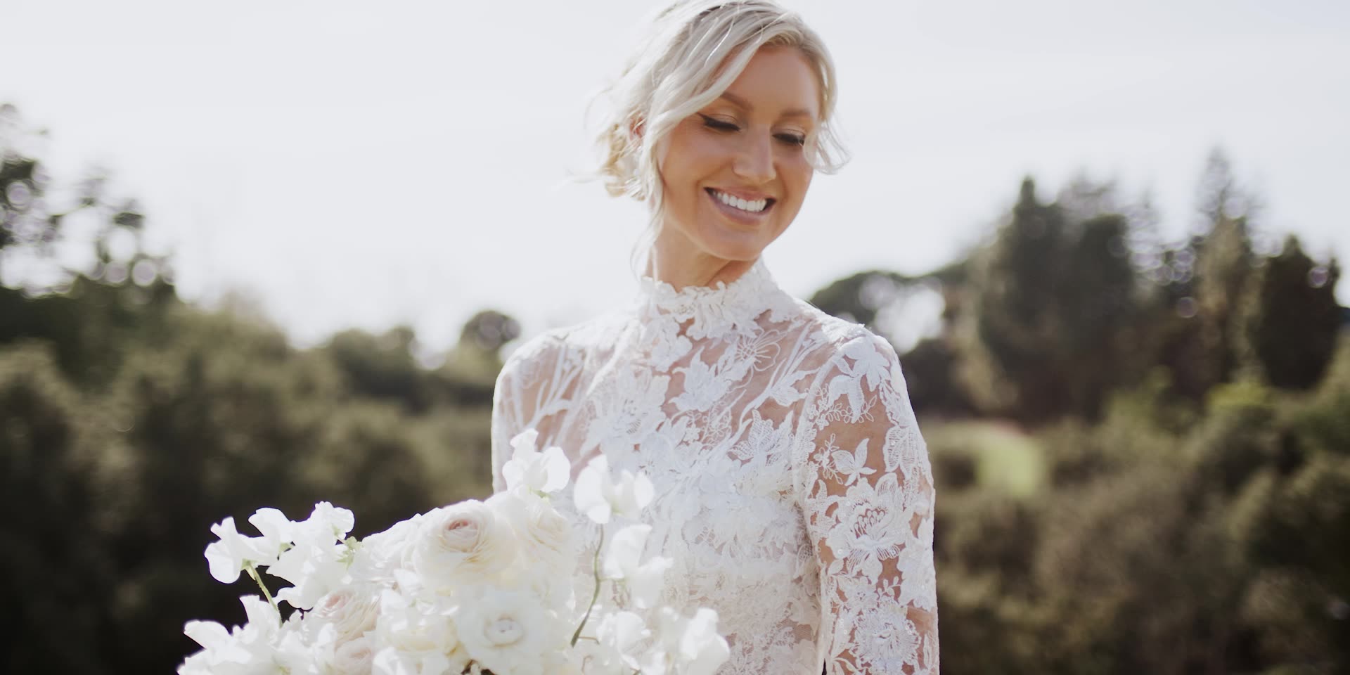 Krista with her white orchid bouquet above the canyon at Bel-Air Country Club