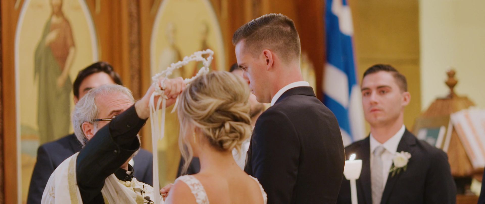 The crowning during the Greek Orthodox ceremony, the stefana held above Teddy and Lindsay.